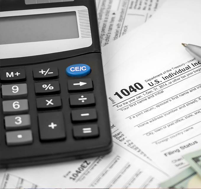 A calculator sitting on top of a 1040 form