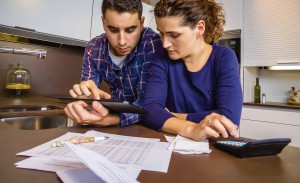 Couple reviewing their accounts with a digital tablet