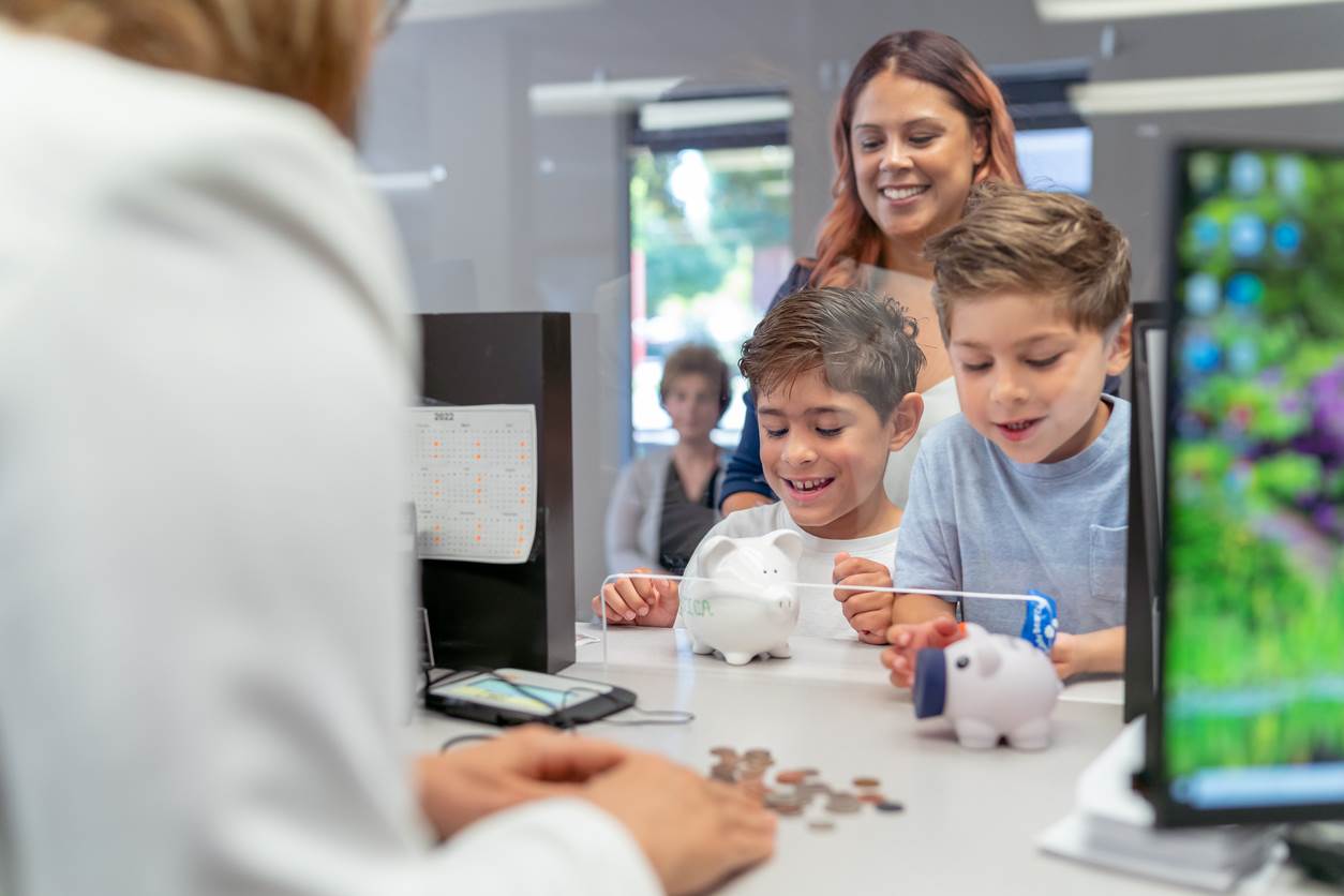 Kids empty piggy banks at the bank