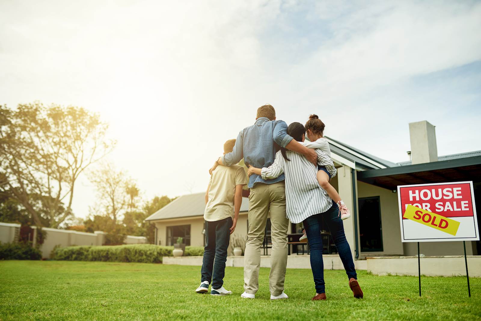 Family in front of sold house